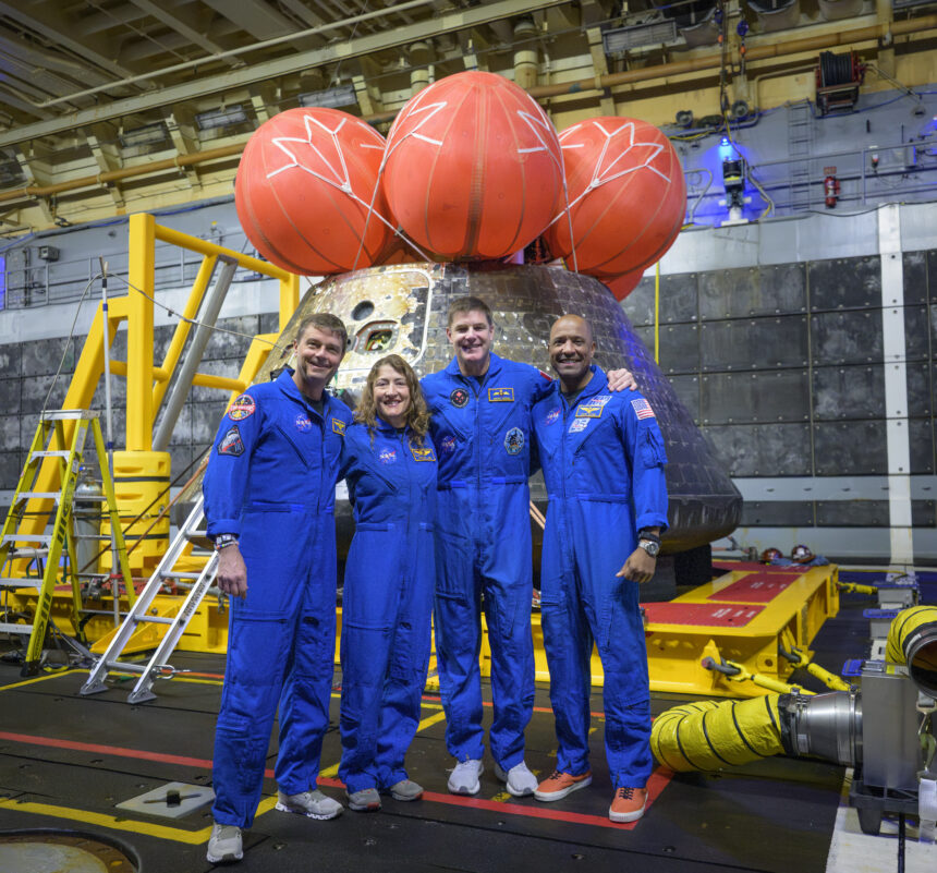NASA astronauts Reid Wiseman, commander; left, Christina Koch, mission specialist; CSA (Canadian Space Agency) astronaut Jeremy Hansen, mission specialist; and NASA astronaut Victor Glover, Artemis II pilot, right, pose for a group photo after viewing the Orion spacecraft in the well deck of USS John P. Murtha, Saturday, April 11, 2026, in the Pacific Ocean off the coast of California. The quartet splashed down Friday, April 10 at 5:07 p.m. PDT (8:07p.m. EDT).
