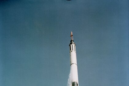 In this view from below, the Mercury-Redstone 3 space vehicle shines in the morning sun as it soars into the blue sky above Cape Canaveral, Florida.
