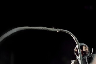 Gemini IX-A astronaut Gene Cernan is backdropped by the blackness of space during America’s second spacewalk on June 5, 1966. His umbilical drifts across the foreground, partially obscuring the view of the astronaut.