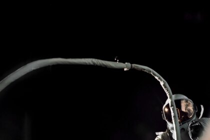 Gemini IX-A astronaut Gene Cernan is backdropped by the blackness of space during America’s second spacewalk on June 5, 1966. His umbilical drifts across the foreground, partially obscuring the view of the astronaut.