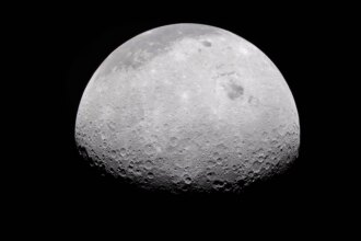 The Moon's rugged surface is on display in this image. Most of the Moon is visible, with the bottom of the sphere disappearing into the darkness. This line between light and dark is called the terminator. The terminator is lined with many craters.