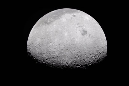 The Moon's rugged surface is on display in this image. Most of the Moon is visible, with the bottom of the sphere disappearing into the darkness. This line between light and dark is called the terminator. The terminator is lined with many craters.