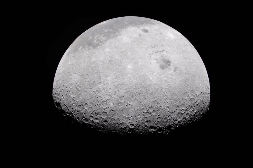 The Moon's rugged surface is on display in this image. Most of the Moon is visible, with the bottom of the sphere disappearing into the darkness. This line between light and dark is called the terminator. The terminator is lined with many craters.