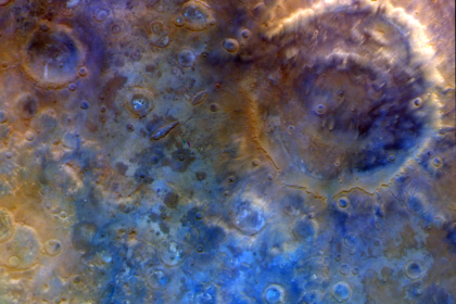 In this representative color image, Mars' surface appears in shades of red, orange, and blue. At right is a double-ring crater called Huygens. To