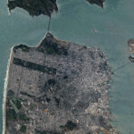 A view of downtown San Francisco from the International Space Station. The city's streets are visible in the daylight, as well as the Golden Gate Bridge to the north and the San Francisco-Oakland Bay Bridge connecting to Oakland to the east.