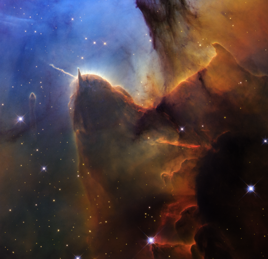 A rich, cosmic landscape is split in two. On the right side, clouds of reddish-black dust billow. On the left, stars sparkle across a dark-blue background.