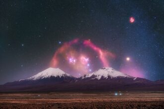 APOD: 2026 July 28 - Barnards Loop over Twin Volcanoes